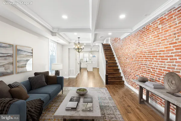 a kitchen with a sink dishwasher a stove and white cabinets with wooden floor