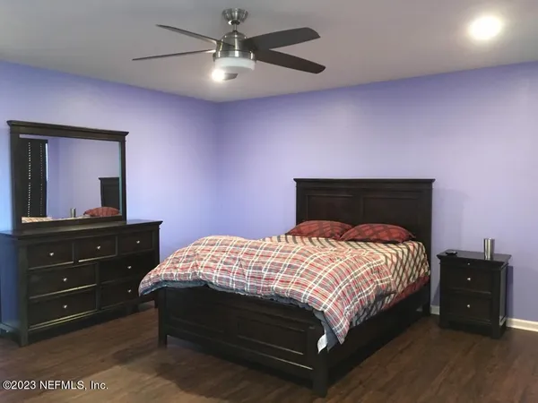 a bedroom with a bed and a dresser