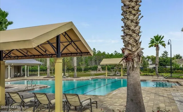 a backyard of a house with table and chairs