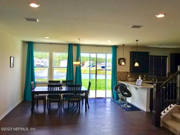 a view of a dining room with furniture window and outside view
