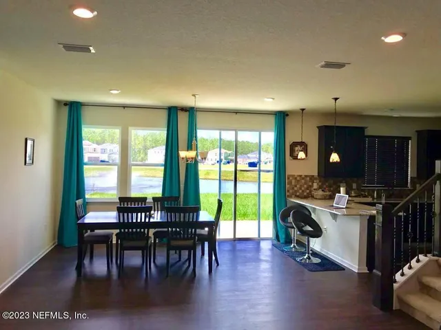 a view of a dining room with furniture window and outside view