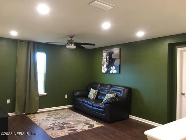 a living room with furniture and a rug