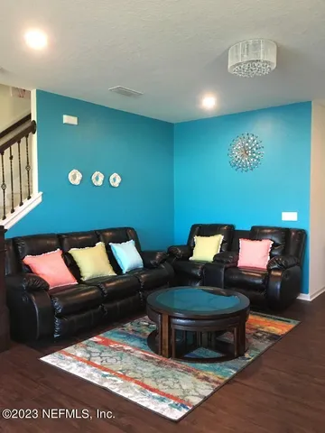 a living room with furniture and a rug