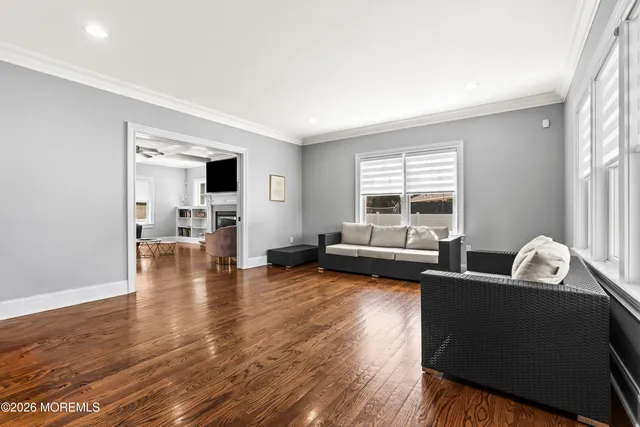 a view of a dining room with furniture a chandelier and wooden floor