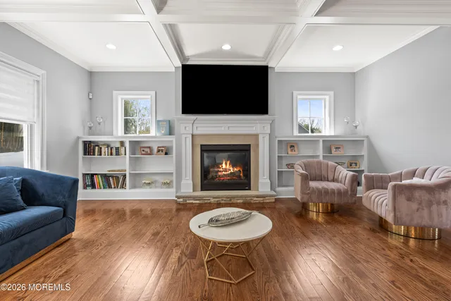 a kitchen with stainless steel appliances granite countertop a table chairs sink refrigerator and cabinets