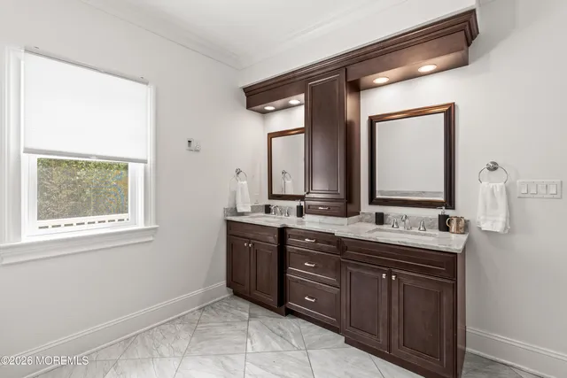 a view of a hallway with wooden floor and closet area