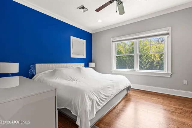 a view of a dining room with furniture a chandelier and wooden floor