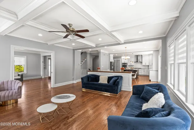a view of a hallway with the wooden floor and staircase