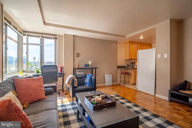 a living room with furniture a window and a flat screen tv