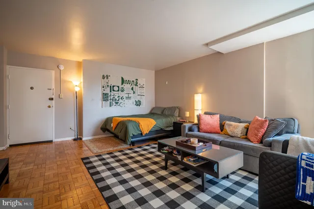 a bedroom with a bed and painting on the wall