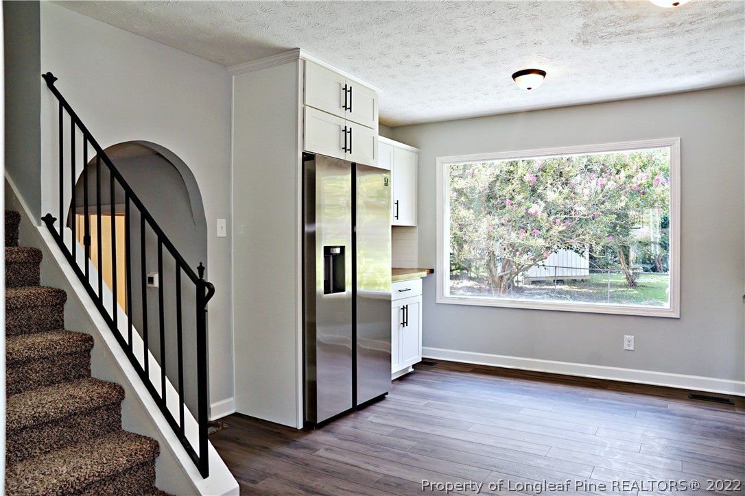 197 Paddle Wheel Road Fayetteville, NC 28314 - Photo 11 of 39 a view of an entryway with wooden floor staircase and windows