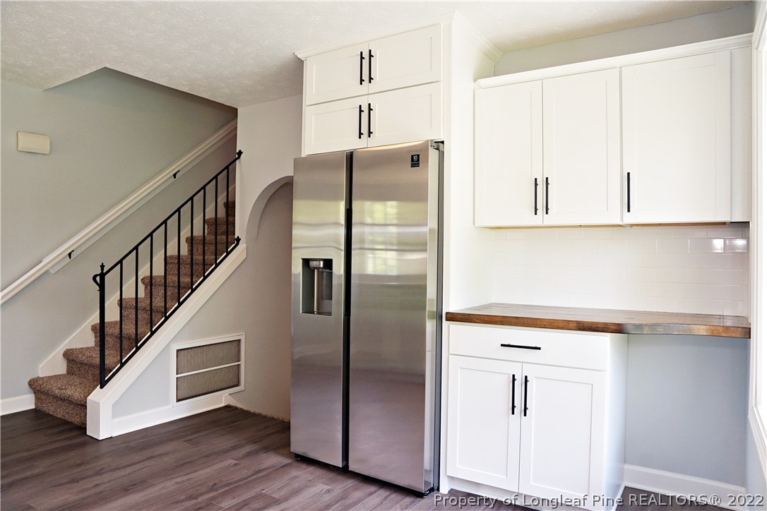 197 Paddle Wheel Road Fayetteville, NC 28314 - Photo 15 of 39 a kitchen with kitchen island white cabinets and wooden floor