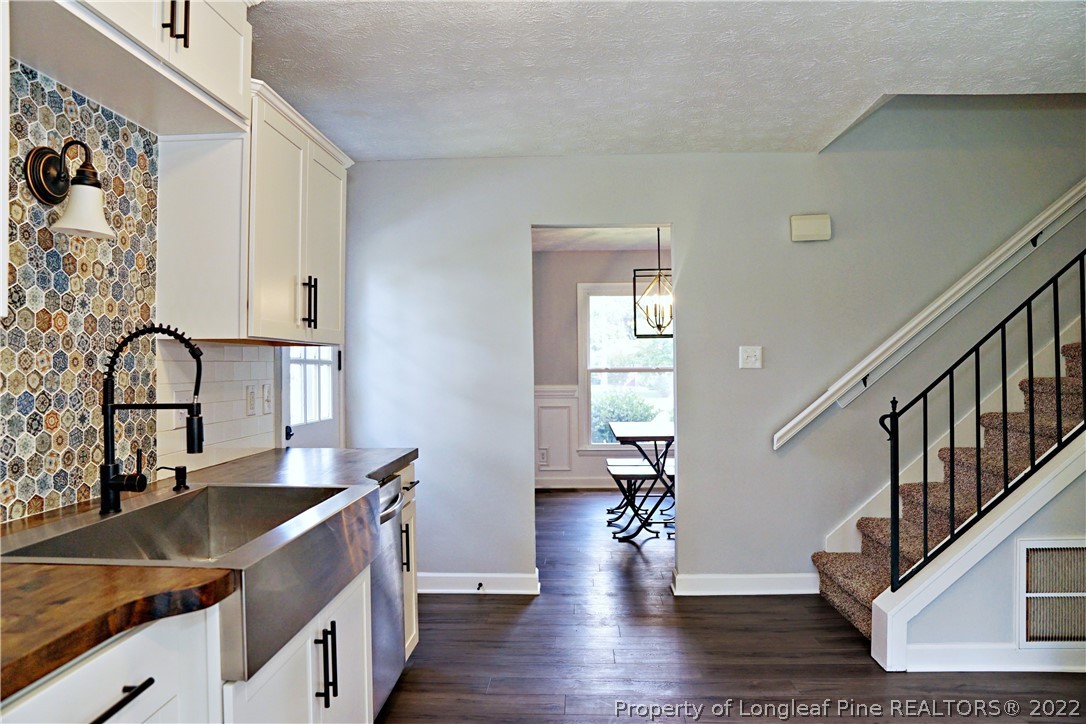 197 Paddle Wheel Road Fayetteville, NC 28314 - Photo 16 of 39 a view of a kitchen with a sink and dishwasher with wooden floor