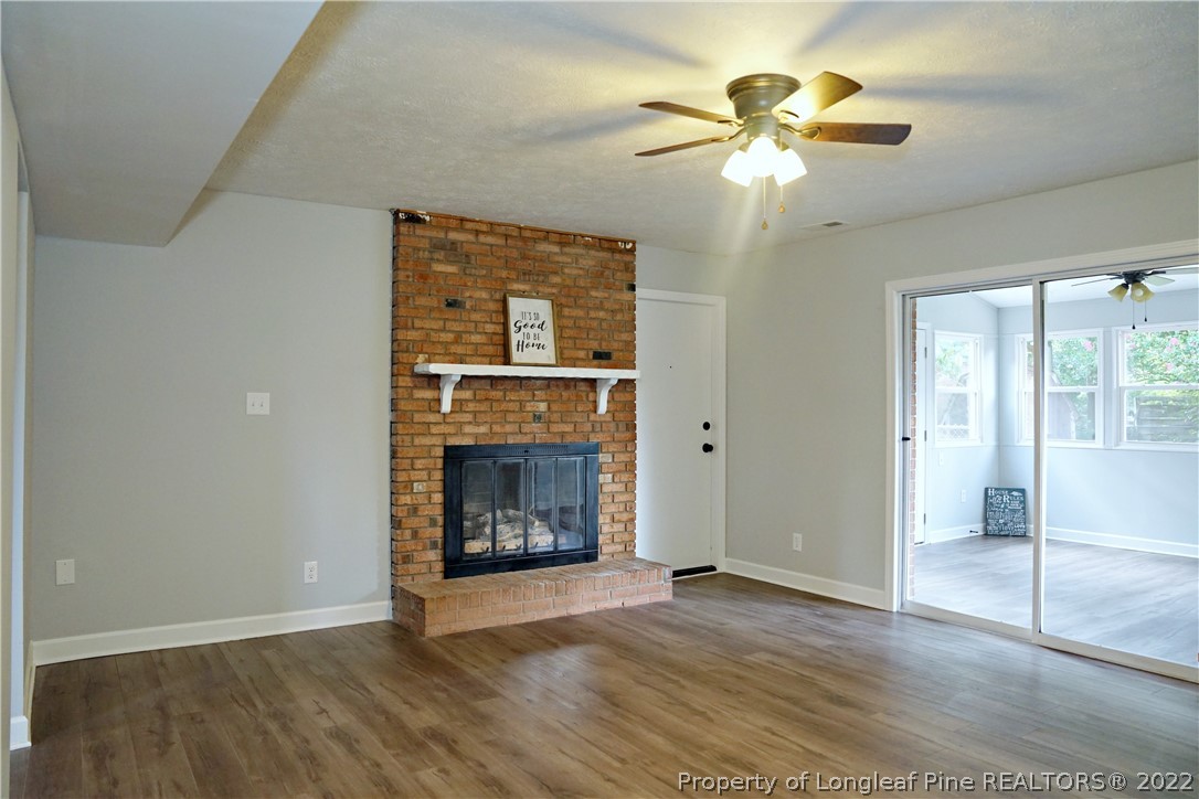 197 Paddle Wheel Road Fayetteville, NC 28314 - Photo 20 of 39 a view of an empty room with a fireplace and a chandelier fan