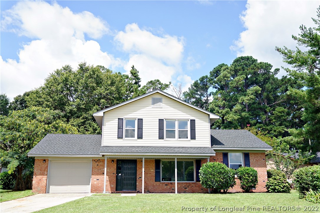 197 Paddle Wheel Road Fayetteville, NC 28314 - Photo 2 of 39 a front view of a house with garden and trees