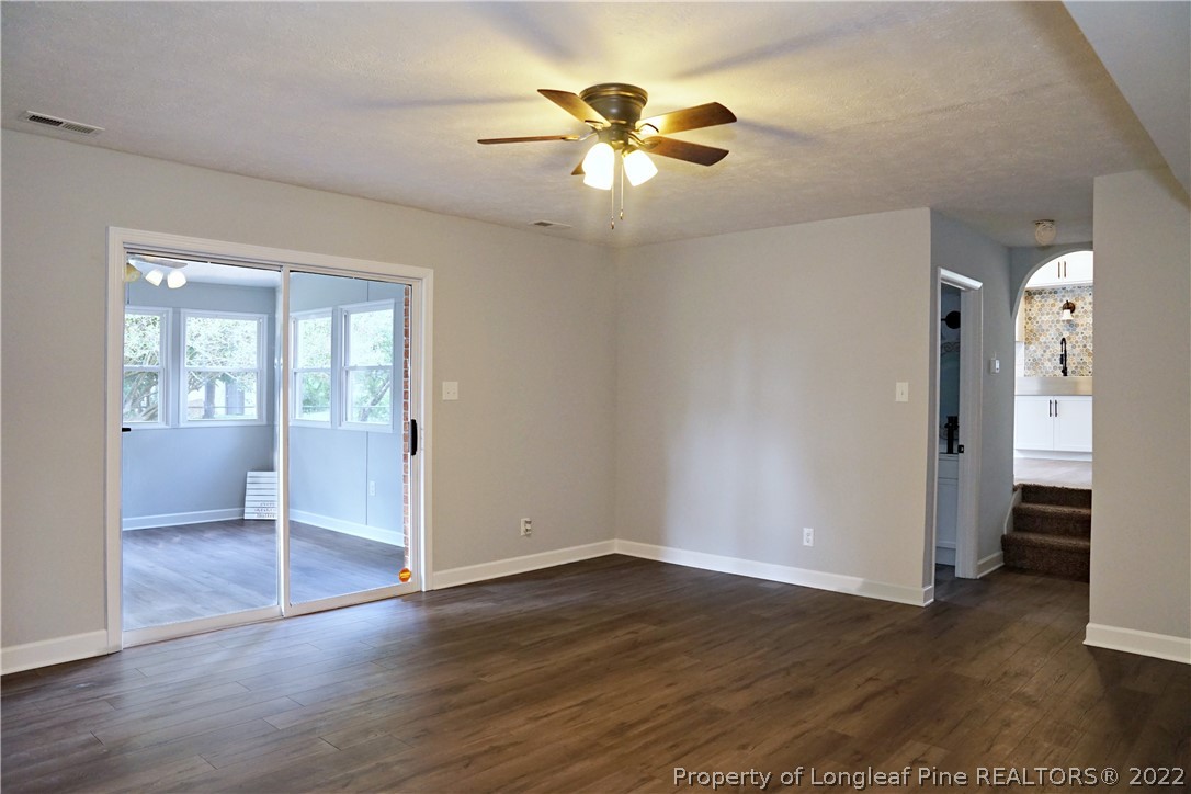 197 Paddle Wheel Road Fayetteville, NC 28314 - Photo 22 of 39 an empty room with wooden floor and a ceiling fan