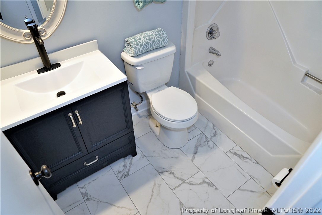 197 Paddle Wheel Road Fayetteville, NC 28314 - Photo 26 of 39 a bathroom with a toilet a sink and bathtub