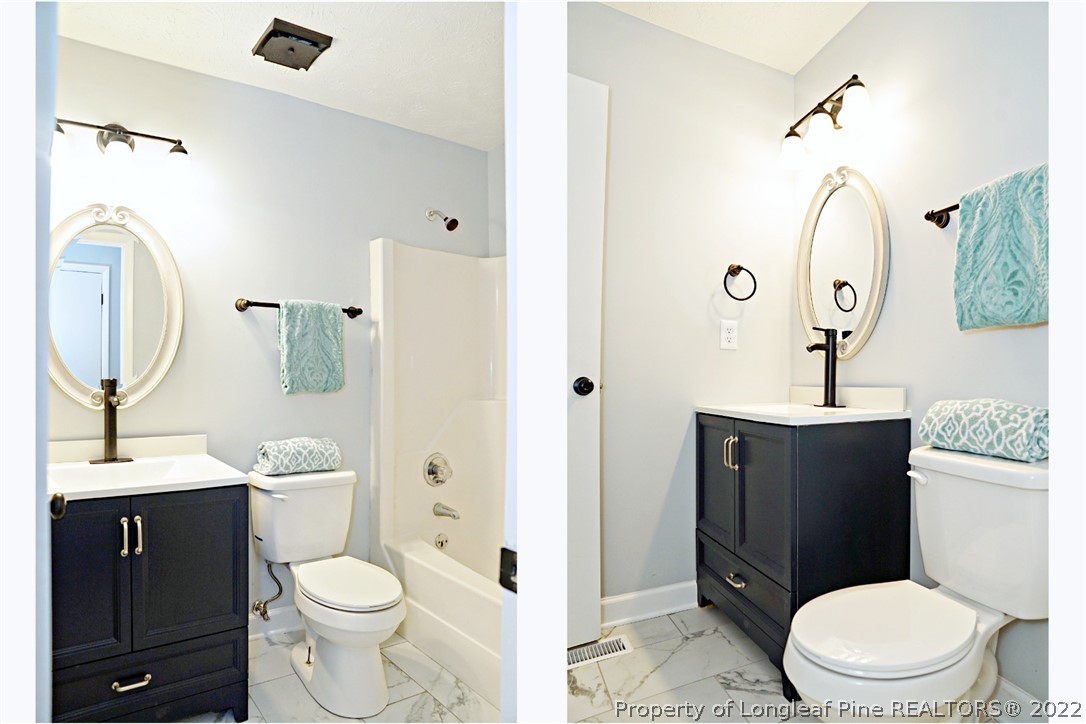 197 Paddle Wheel Road Fayetteville, NC 28314 - Photo 27 of 39 a bathroom with a toilet a sink a mirror a vanity and window