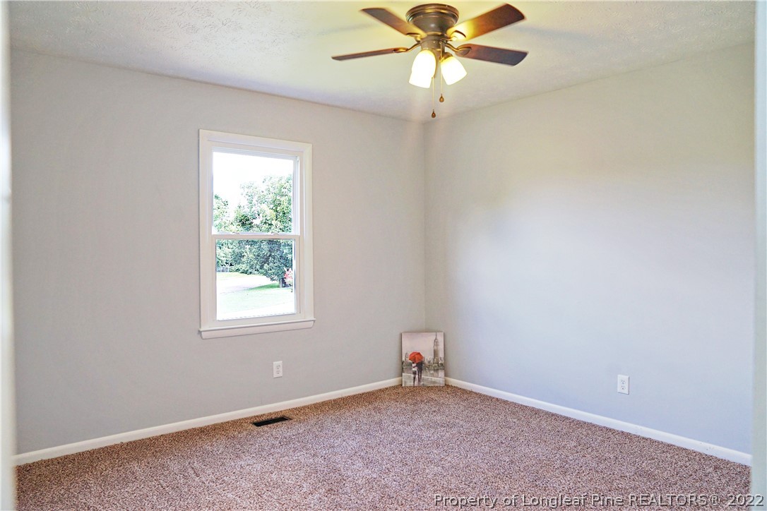 197 Paddle Wheel Road Fayetteville, NC 28314 - Photo 31 of 39 an empty room with a window and a fan