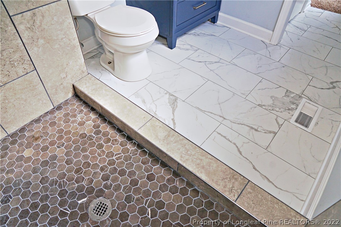 197 Paddle Wheel Road Fayetteville, NC 28314 - Photo 39 of 39 a bathroom with a toilet and a rug