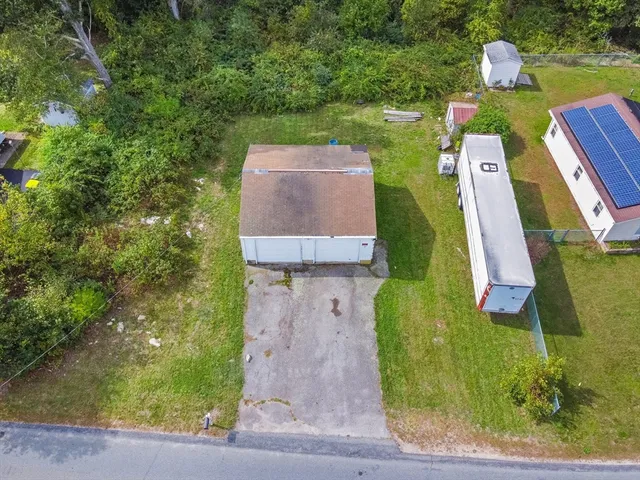 an aerial view of a house with a garden and swimming pool