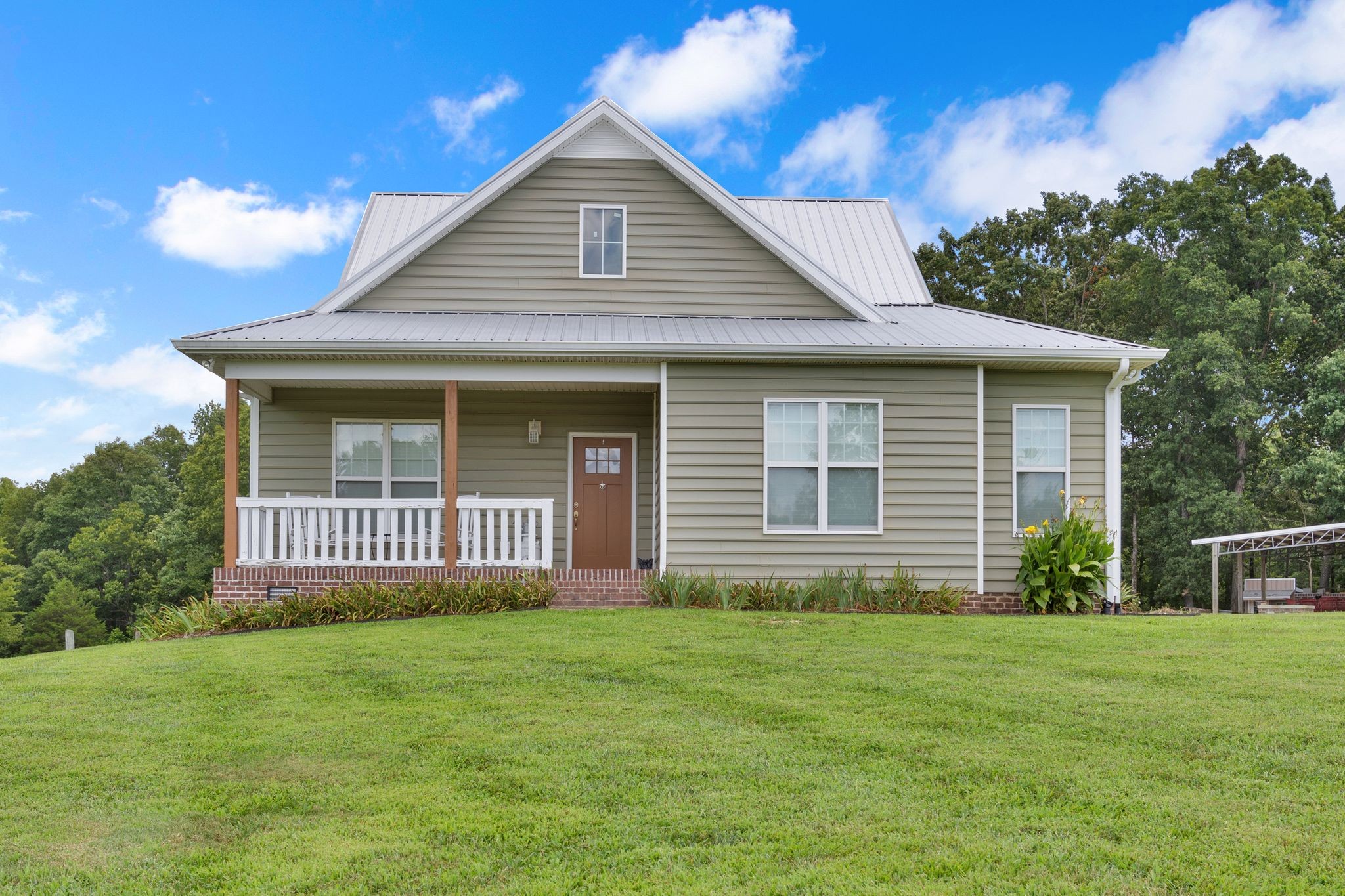 a front view of a house with a garden