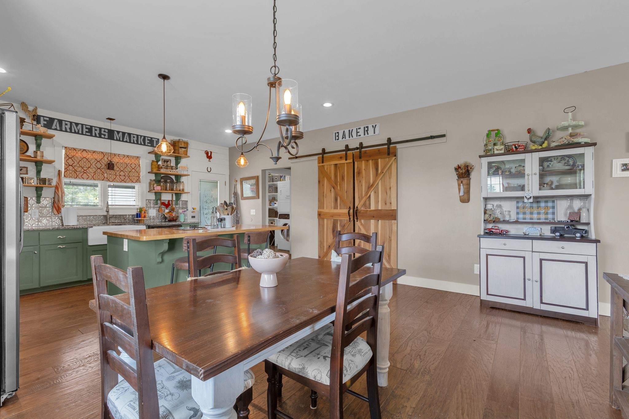 828 Wills Road Dickson, TN 37055 - Photo 12 of 53 a dining table with chairs and kitchen view