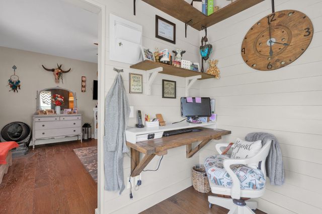 a view of living room filled with furniture and baby bed