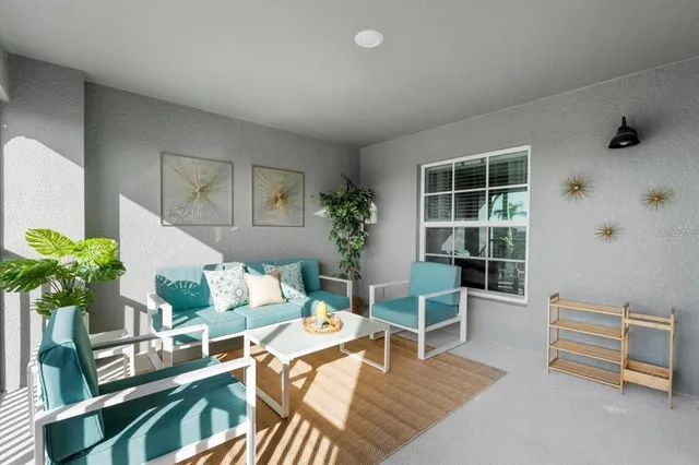 a living room with furniture flowerpot and wooden floor