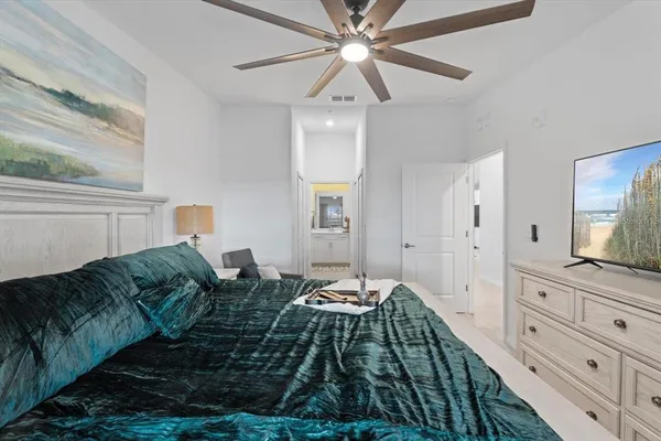 a bedroom with a bed and a chandelier