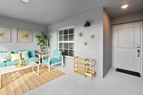 a living room with furniture and a large window