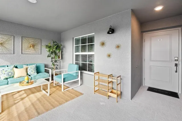 a living room with furniture and a large window