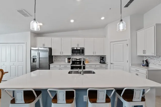 a view of a dining room with furniture wooden floor and chandelier