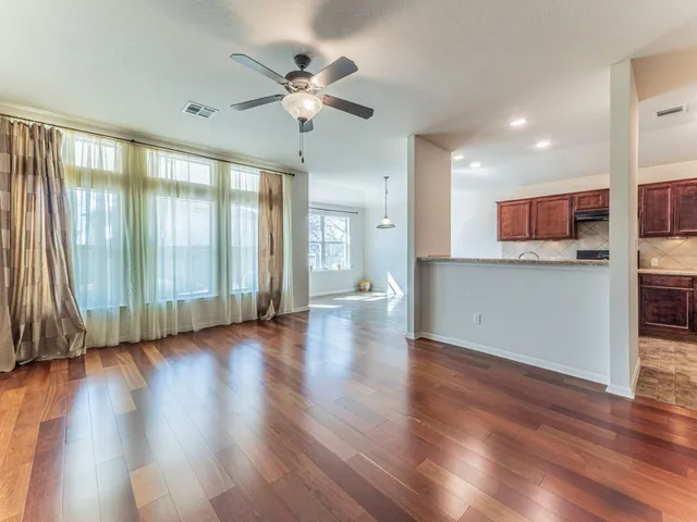 a view of a kitchen with a dishwasher cabinets and wooden floor