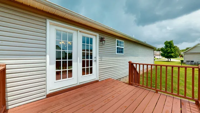 a view of a house with wooden deck