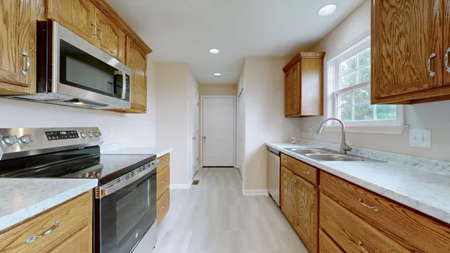 a kitchen with a sink stove and microwave