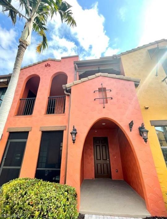 9050 Capistrano Street North, Unit 4102 Naples, FL 34113 - Photo 5 of 31 a front view of a house with garden