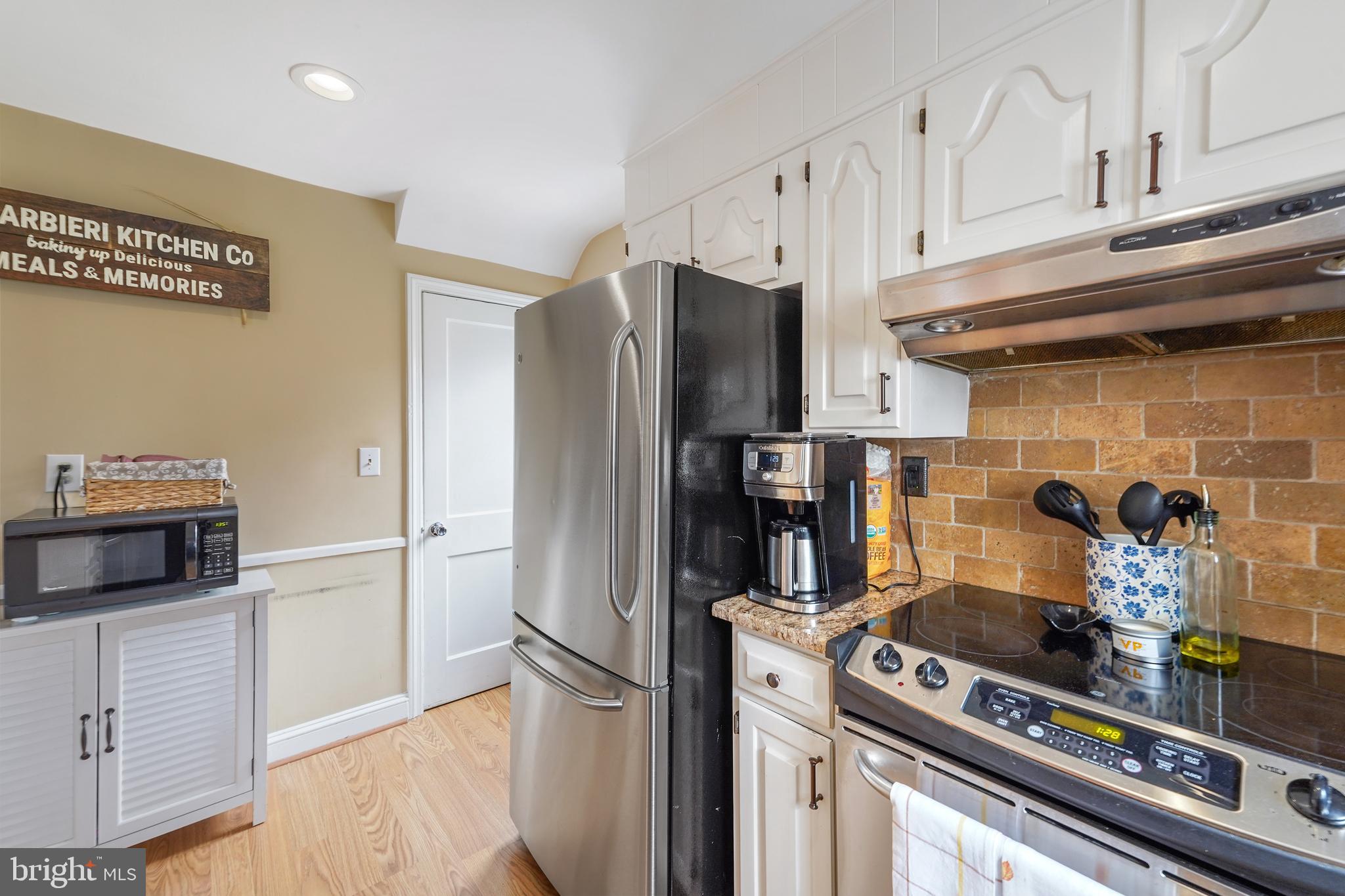 311 Avon Road Springfield, PA 19064 - Photo 13 of 38 a kitchen with a stove and a refrigerator