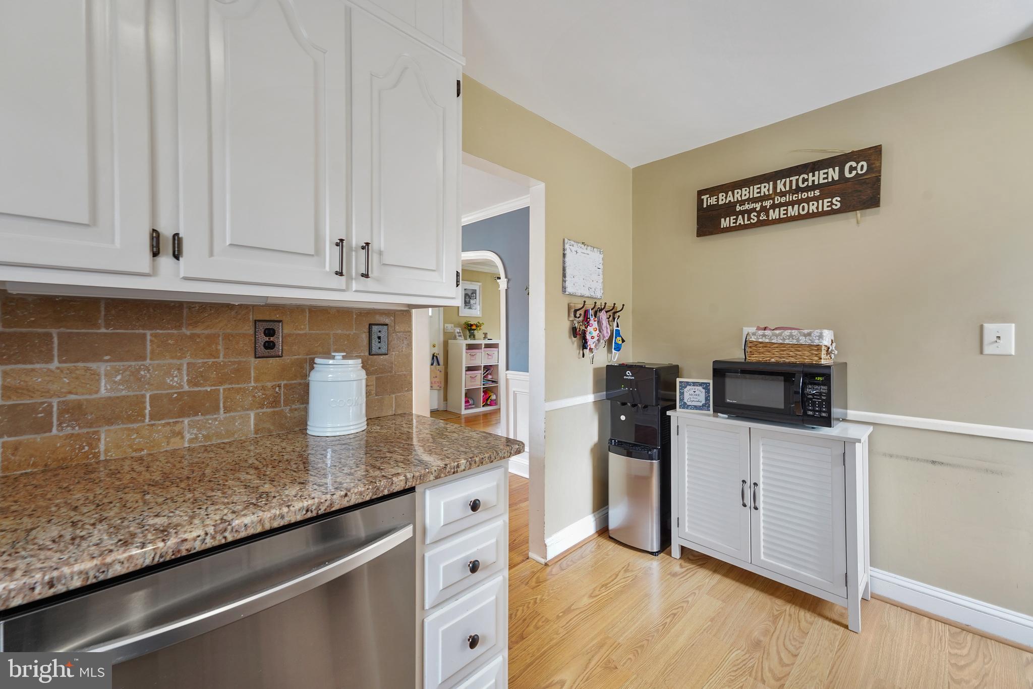 311 Avon Road Springfield, PA 19064 - Photo 14 of 38 a kitchen with granite countertop a sink a stove and cabinets