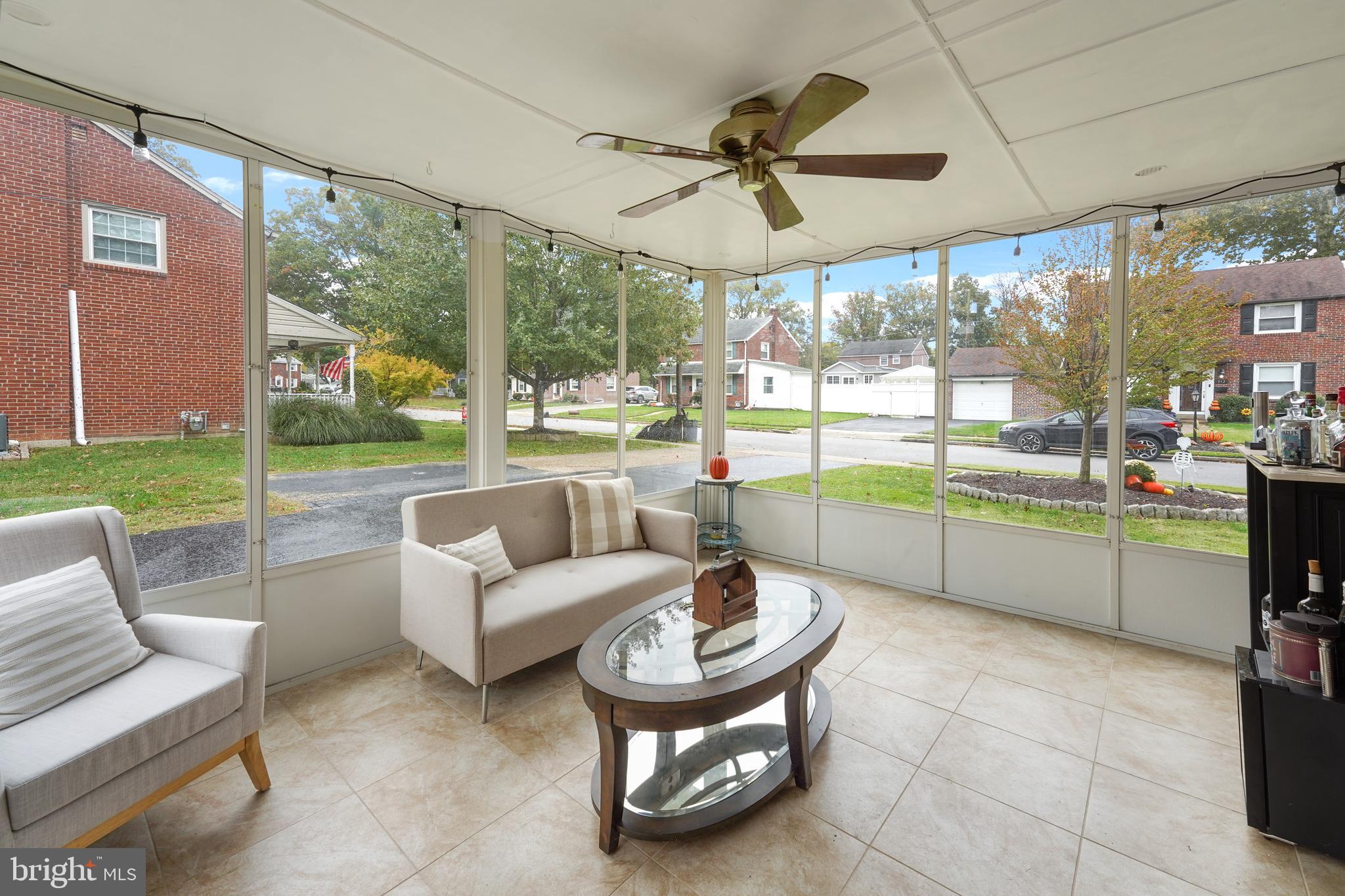 311 Avon Road Springfield, PA 19064 - Photo 15 of 38 a living room with furniture and a floor to ceiling window