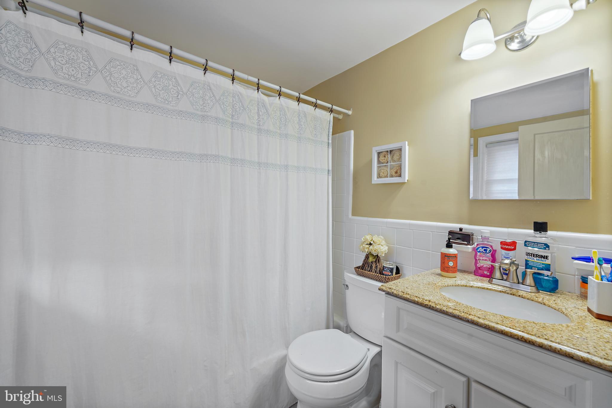 311 Avon Road Springfield, PA 19064 - Photo 27 of 38 a bathroom with a granite countertop sink and a mirror