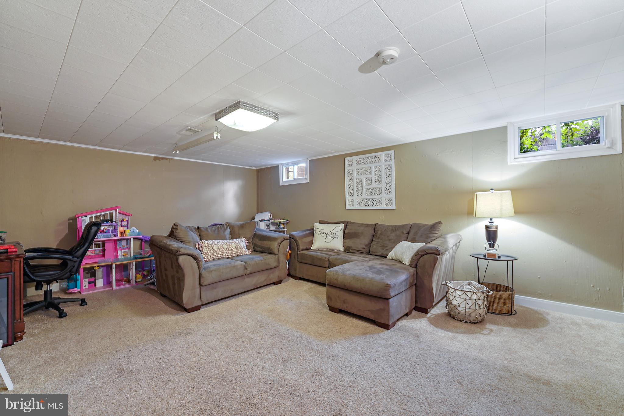 311 Avon Road Springfield, PA 19064 - Photo 28 of 38 a living room with furniture and a lamp