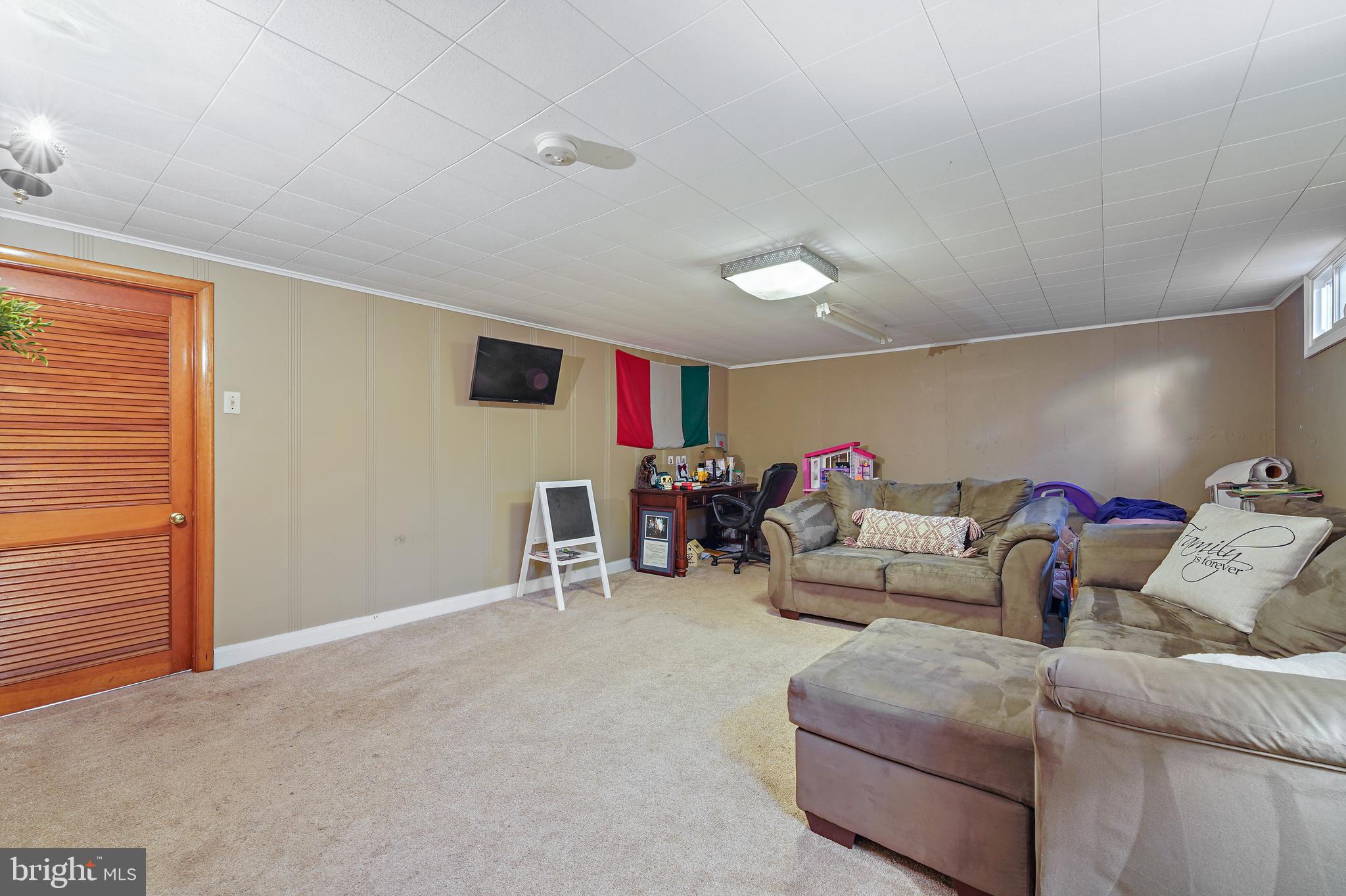 311 Avon Road Springfield, PA 19064 - Photo 30 of 38 a living room with furniture and a flat screen tv