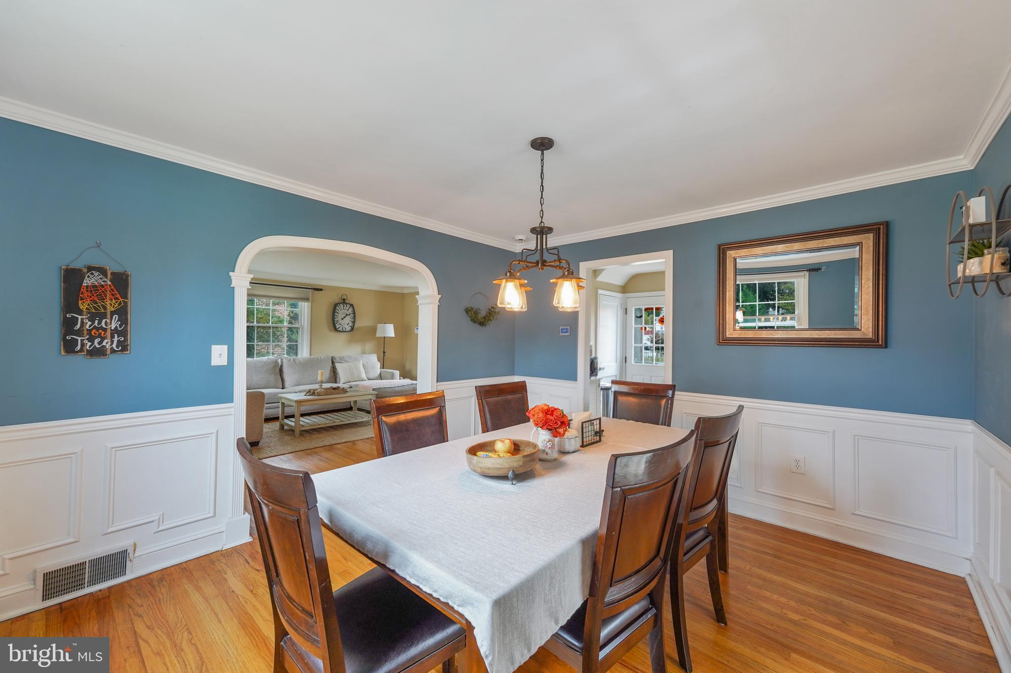 311 Avon Road Springfield, PA 19064 - Photo 8 of 38 a dining room with furniture a chandelier and wooden floor
