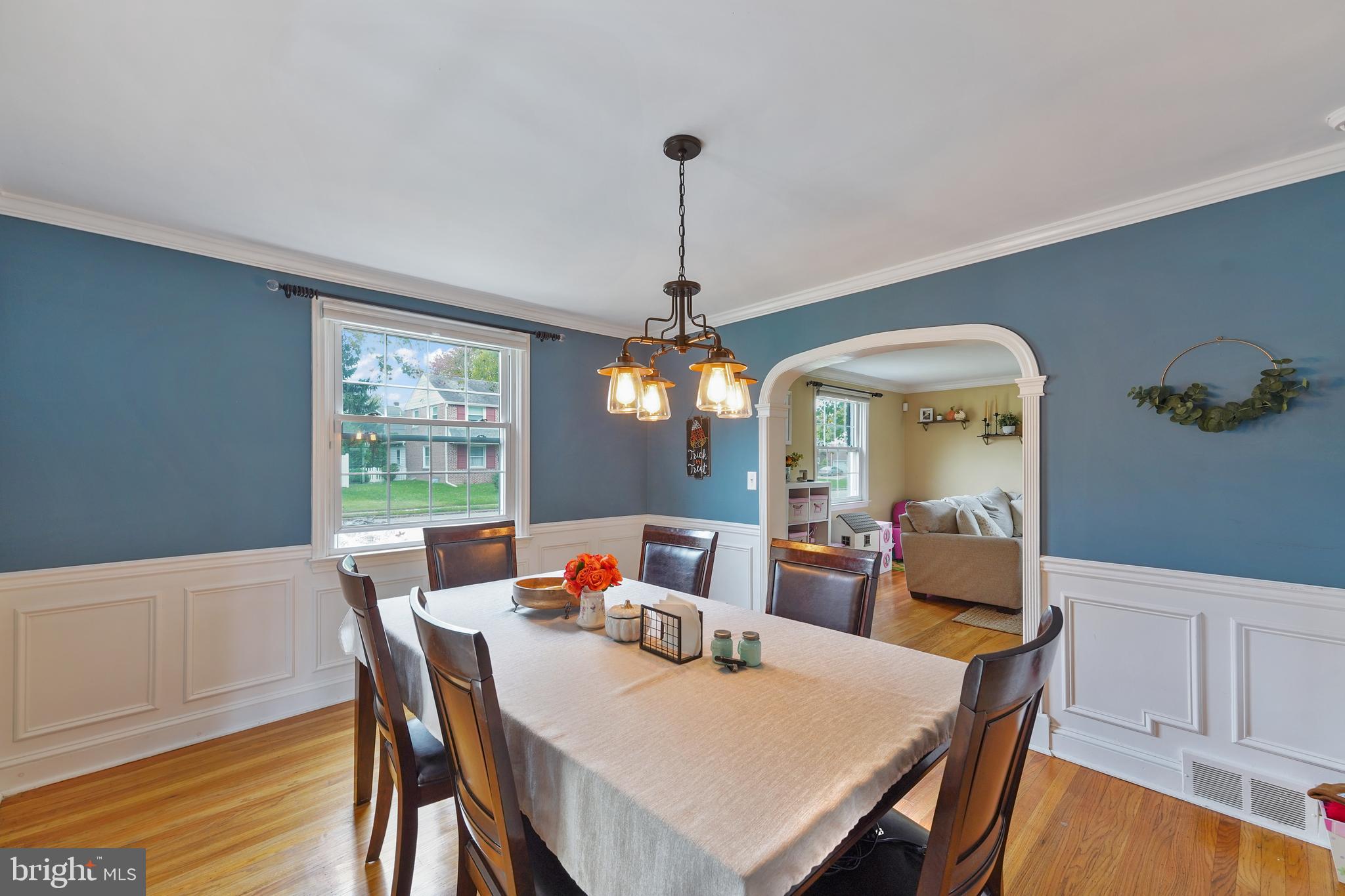 311 Avon Road Springfield, PA 19064 - Photo 9 of 38 a dining room with furniture a chandelier and wooden floor