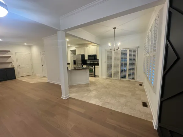 a view of a livingroom with a furniture wooden floor and a window
