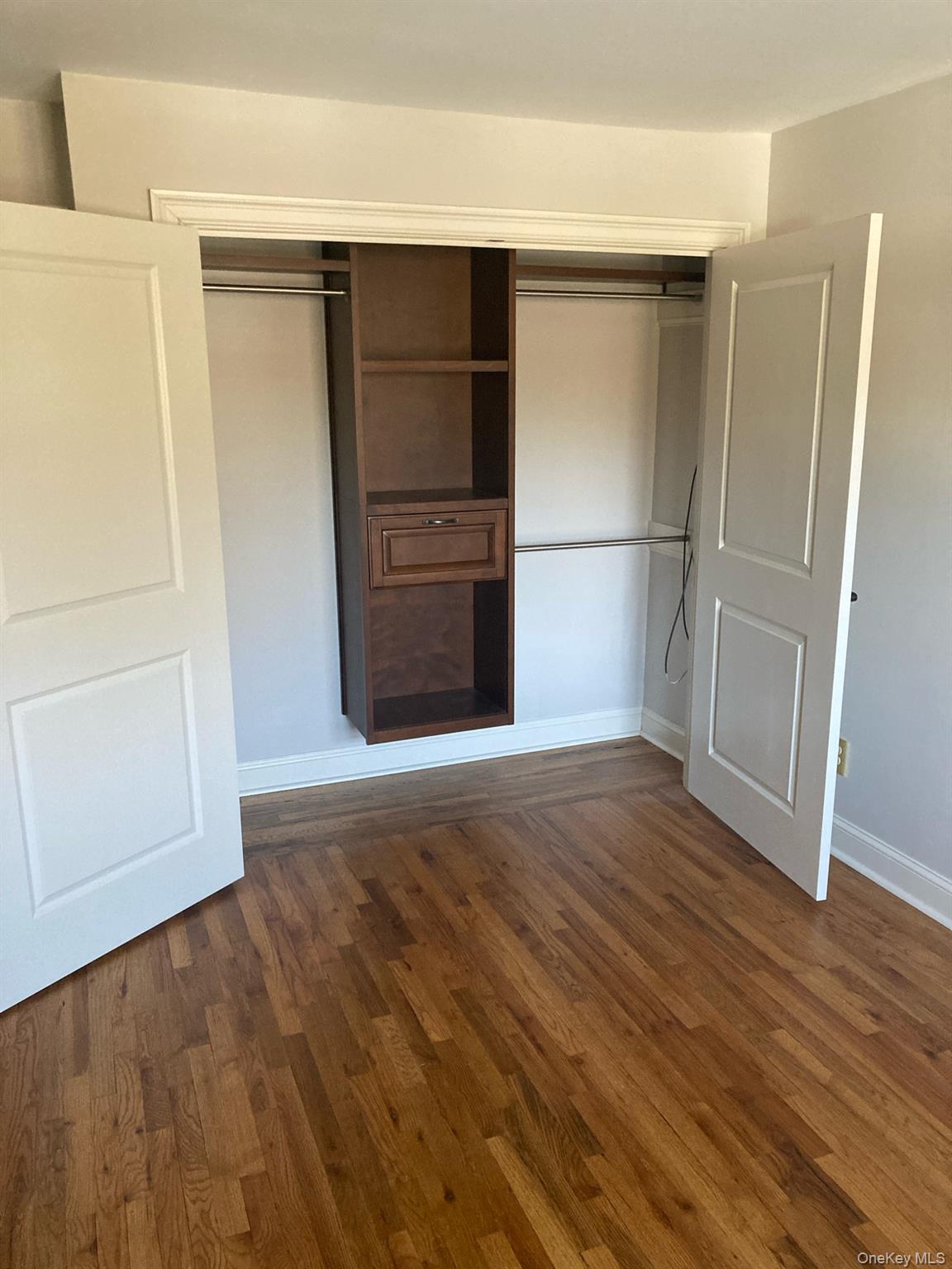 2 Colonial Road, Unit 126 Beacon, NY 12508 - Photo 7 of 11 Unfurnished bedroom featuring a closet and dark wood finished floors