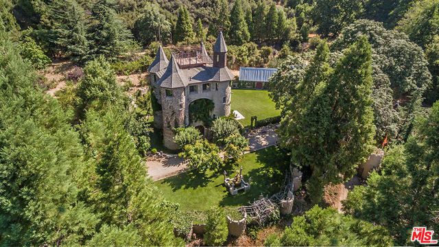 an aerial view of a house with a yard