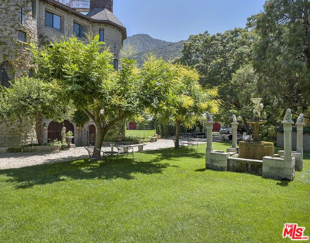 a backyard of a house with table and chairs