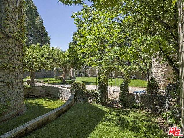 a view of a backyard with sitting area